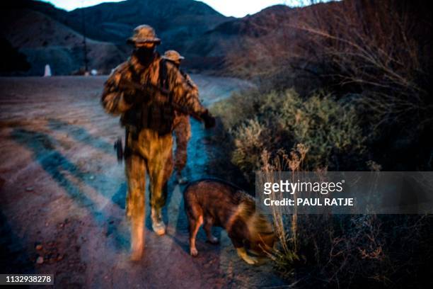 Members of the Constitutional Patriots New Mexico Border Ops Team militia, Viper and Stinger who go by aliases to protect their identity, patrol the...