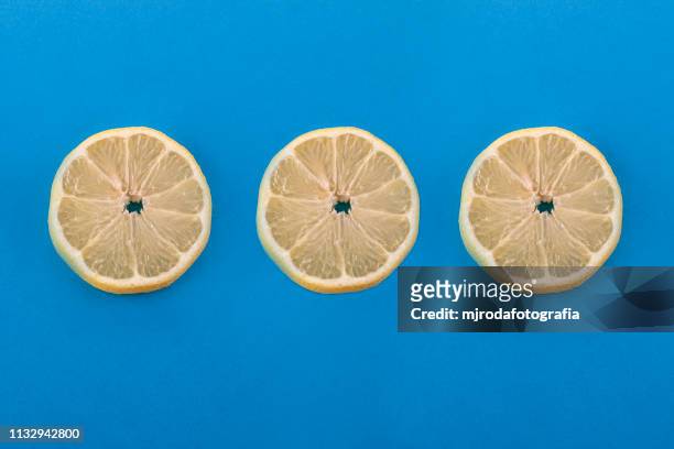 three lemon slices. - comida vegetariana stockfoto's en -beelden