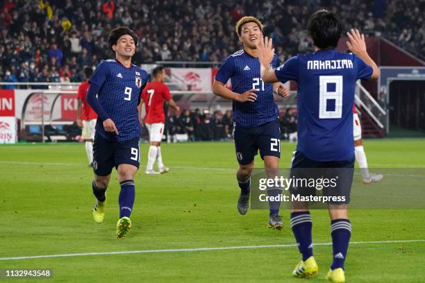 Shoya Nakajima of Japan celebrates scoring the opening goal with Takumi Minamino and Ritsu Doan of Japan during the international friendly match...