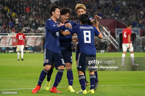 Shoya Nakajima of Japan celebrates scoring the opening goal with Daichi Kamada ,Takumi Minamino and Ritsu Doan of Japan during the international...