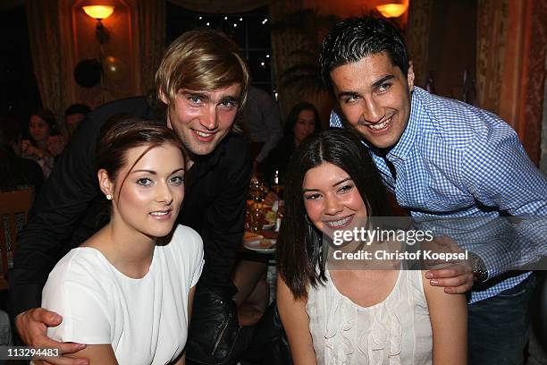 Anika, girl-friedn of Marcel Schmelzer , Tugba Sahin and Nuri Sahin, pose before celebrate winning the German Championships at a restaurant on April...