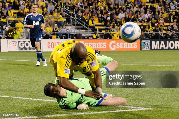 Emilio Renteria of the Columbus Crew collides with goalkeeper Jay Nolly of the Vancouver Whitecaps FC in the second half on April 30, 2011 at Crew...