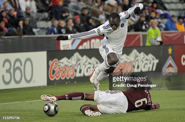 Dominic Oduro of the Chicago Fire leaps to avoid the sliding tackle of Anthony Wallace of the Colorado Rapids at Dick's Sporting Goods Park on April...