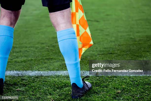 assistant referee signals with flag in the soccer field - europa referee foto e immagini stock