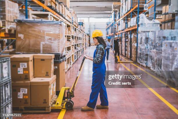 warehouse employees working with boxes - pallet jack stock pictures, royalty-free photos & images