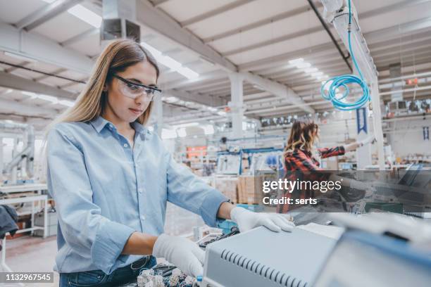 young women working on the production line in factory - electronics manufacturing stock pictures, royalty-free photos & images