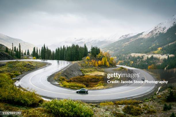 vehicles on mountain road - bergstrasse stock-fotos und bilder