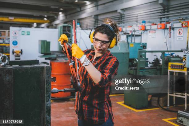 hardworking young woman in metal industry - security equipment stock pictures, royalty-free photos & images