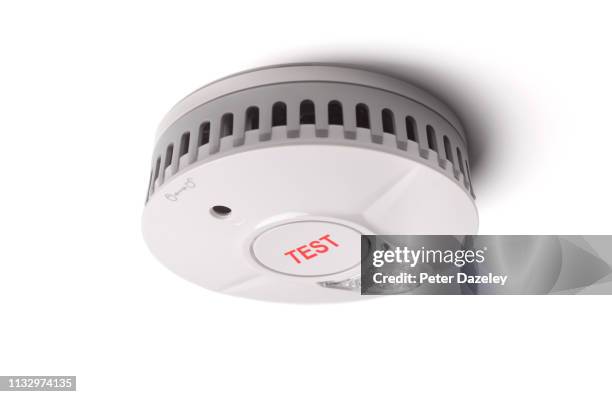 smoke alarm / heat detector on ceiling - uk fire rescue stock pictures, royalty-free photos & images