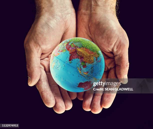 asia globe in hands - india china stock pictures, royalty-free photos & images