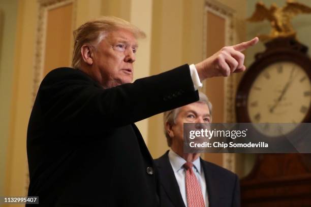 President Donald Trump answers questions from the media alongside Sen. Roy Blunt after arriving at the U.S. Capitol before joining Senate Republicans...