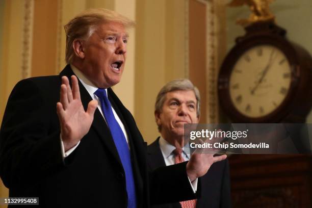 President Donald Trump answers questions from the media alongside Sen. Roy Blunt after arriving at the U.S. Capitol before joining Senate Republicans...