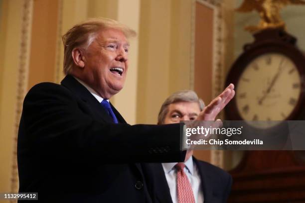 President Donald Trump answers questions from the media alongside Sen. Roy Blunt after arriving at the U.S. Capitol before joining Senate Republicans...