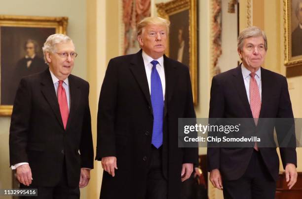 President Donald Trump arrives at the U.S. Capitol alongside U.S. Senate Majority Leader Sen. Mitch McConnell and Sen. Roy Blunt before joining...