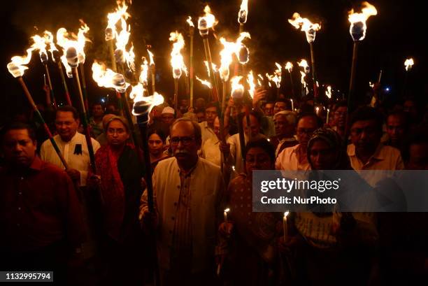 Members of civil society hold torches during a rally in remembrance of 'Black Night 1971' in Dhaka, Bangladesh, on March 25, 2019. The day marks...