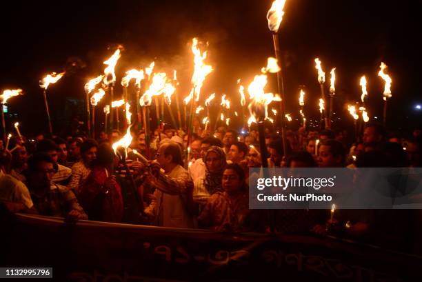 Members of civil society hold torches during a rally in remembrance of 'Black Night 1971' in Dhaka, Bangladesh, on March 25, 2019. The day marks...