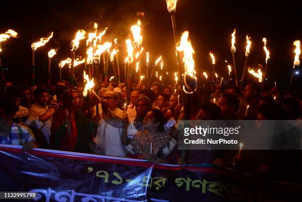 Members of civil society hold torches during a rally in remembrance of 'Black Night 1971' in Dhaka, Bangladesh, on March 25, 2019. The day marks...