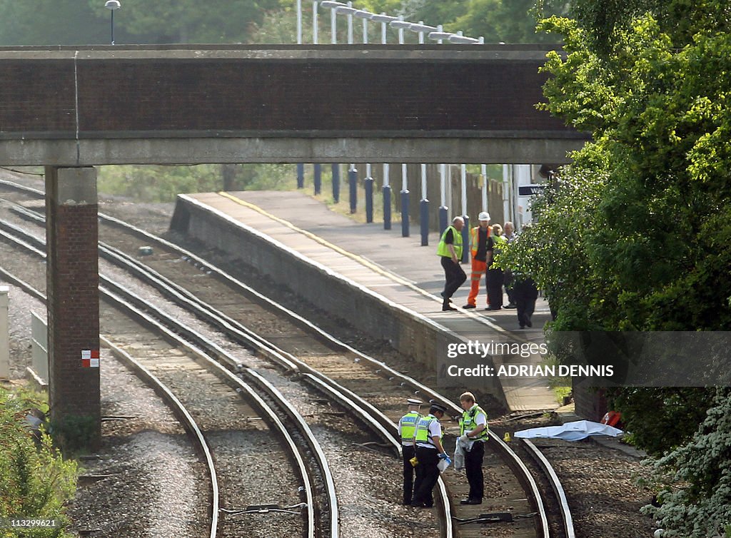 Police officers examine the westbound tr