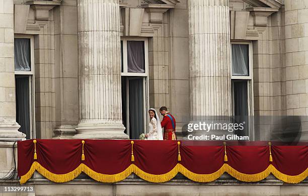 Princess Catherine looks back at well-wishers as Prince William walks with her from the balcony at Buckingham Palace on April 29, 2011 in London,...