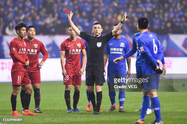 Referee Milorad Mazic shows a red card during the first round match of 2019 Chinese Football Association Super League between Shanghai Shenhua and...