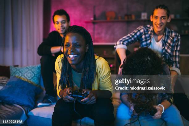 girls playing video games at home - online game friends stock pictures, royalty-free photos & images