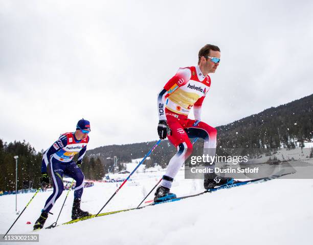 Sjur Roethe of Norway and Matti Heikkinen of Finland compete in the Men's 4x10km Cross Country relay during the FIS Nordic World Ski Championships on...