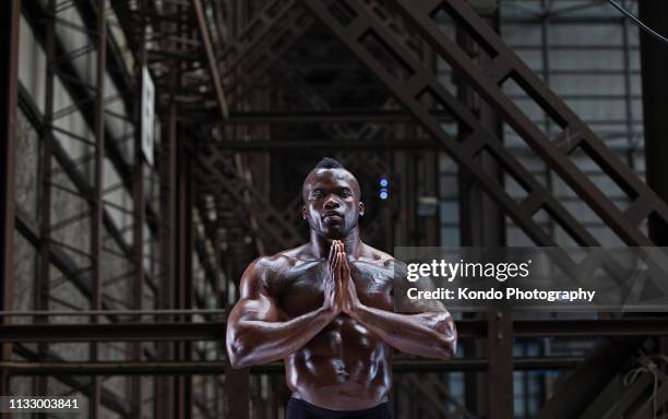 bare-chested athlete in prayer position - athlete torso stock pictures, royalty-free photos & images