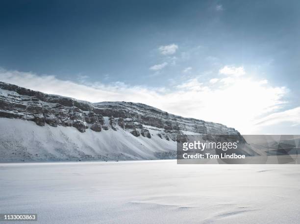 mountains and snow-covered field - arctic stock pictures, royalty-free photos & images