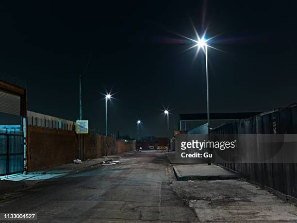 industrial district at night - alley stock-fotos und bilder