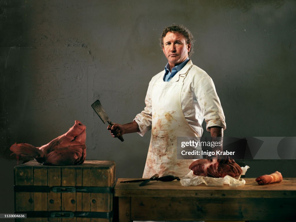 Butcher preparing meat from pig