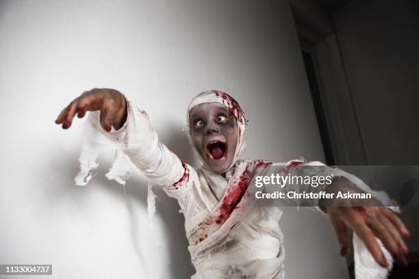 child dressed as mummy for halloween - halloween zombie stock pictures, royalty-free photos & images