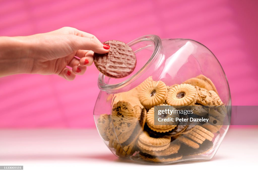 Woman stealing biscuit, caught in the act.