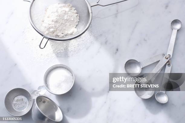 flour with measuring cups and spoons - powdered sugar stock pictures, royalty-free photos & images