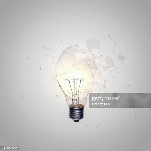 close up of light bulb shattering - broken lamp stockfoto's en -beelden