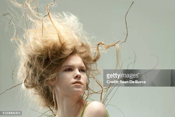 portrait of young woman with unusual hairstyle - beehive hair stock pictures, royalty-free photos & images