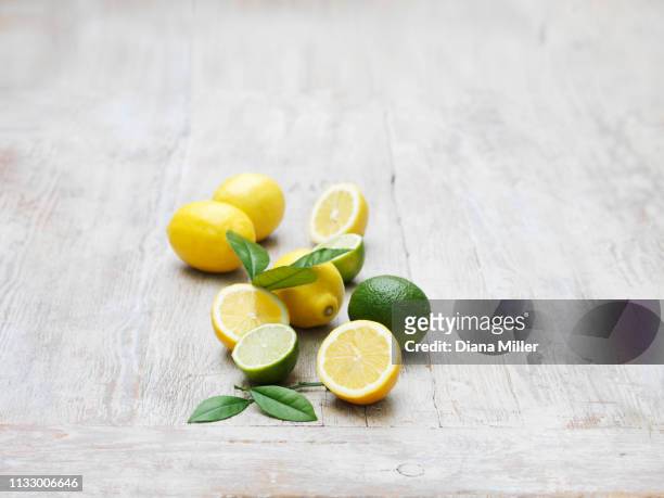 lemons and limes on whitewashed wooden table - whitewashed stock pictures, royalty-free photos & images
