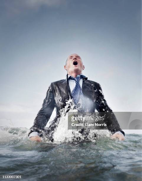 a businessman coming out of the sea - appearance foto e immagini stock