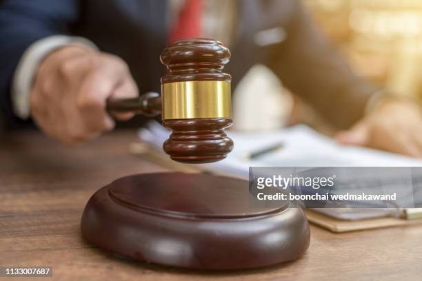 close up lawyer businessman working or reading lawbook in office workplace for consultant lawyer concept. - hammer stock-fotos und bilder