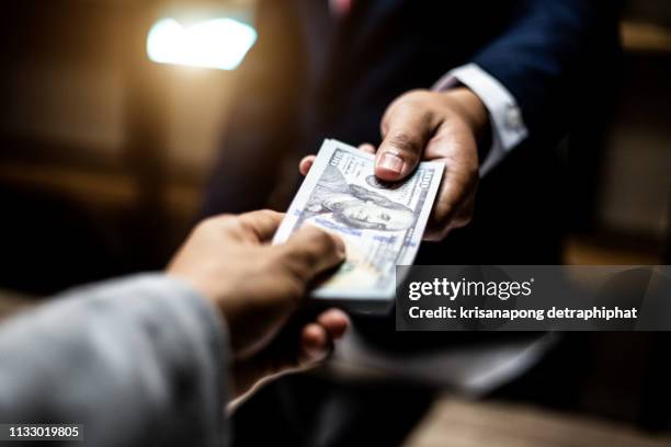 corruption,business concept,corruption concept - pay cash stock-fotos und bilder