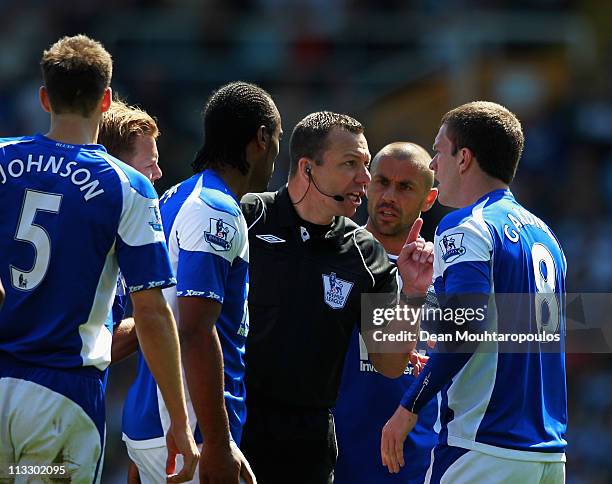 Referee, Kevin Friend speaks to Craig Gardner of Birmingham after showing him his second yellow and then a red card during the Barclays Premier...