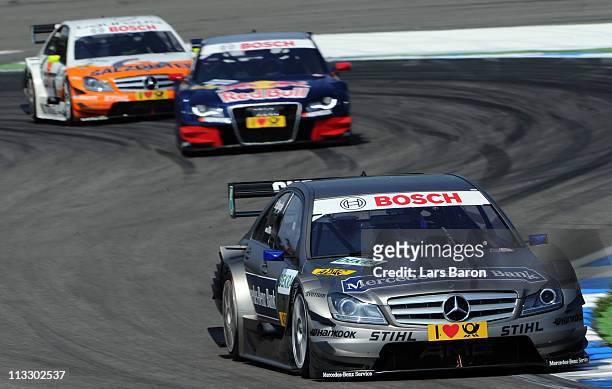Bruno Spengler of Canada and Mercedes Benz Bank AMG Mercedes takes an early lead of Mattias Ekstroem of Swden and Audi Sport Team Abt Sportsline and...