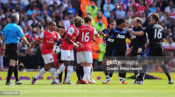 Arsenal and Manchester United players clash during the Barclays Premier League match between Arsenal and Manchester United at the Emirates Stadium on...