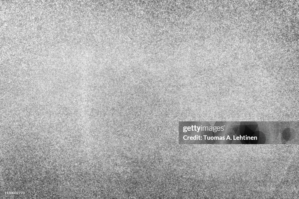 Natural granite stone abstract texture background with vignetting in black and white.