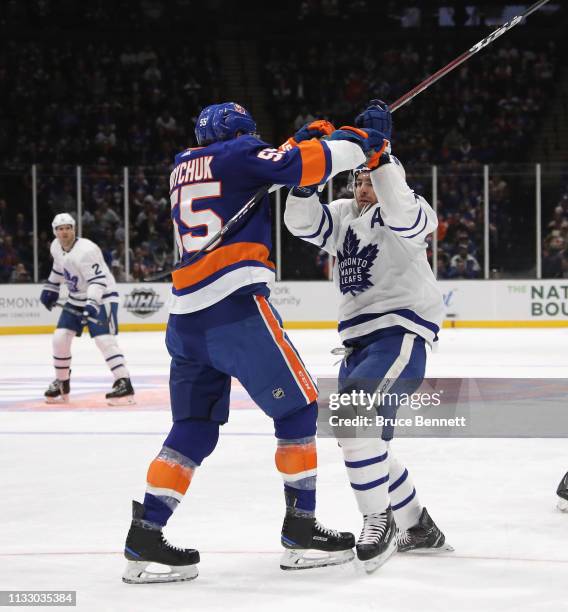 Johnny Boychuk of the New York Islanders checks John Tavares of the Toronto Maple Leafs at NYCB Live's Nassau Coliseum on February 28, 2019 in...