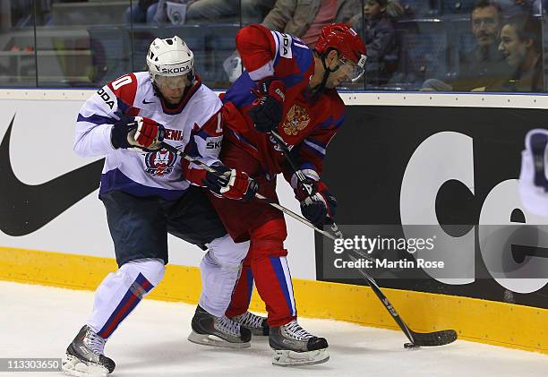 Fyodor Tyutin of Russia and Mitja Sivic of Slovenia battle for the puck during the IIHF World Championship group A match between Russia and Slovenia...