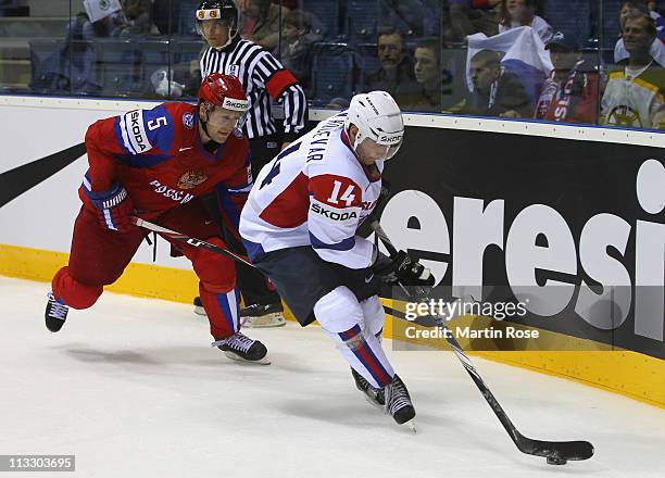 Ilya Nikulin of Russia and Matej Hocevar of Slovenia battle for the puck during the IIHF World Championship group A match between Russia and Slovenia...