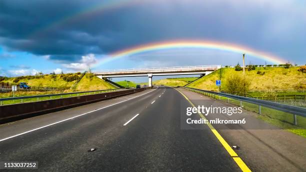 view of a car window during rain. double rainbow, irish landscape scenery - ireland rainbow stock pictures, royalty-free photos & images