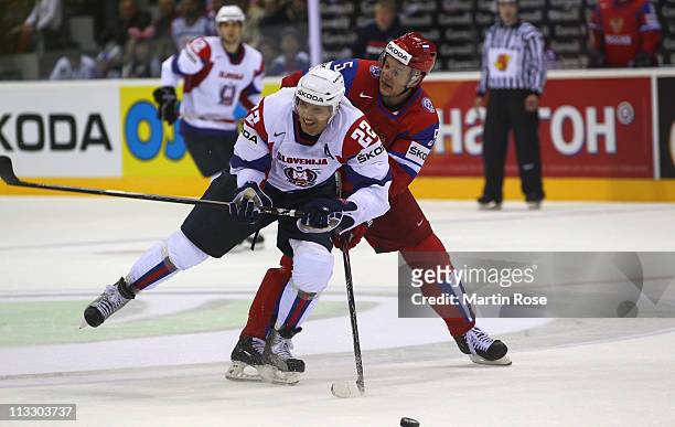 Ilya Nikulin of Russia and Marcel Rodman of Slovenia battle for the puck during the IIHF World Championship group A match between Russia and Slovenia...