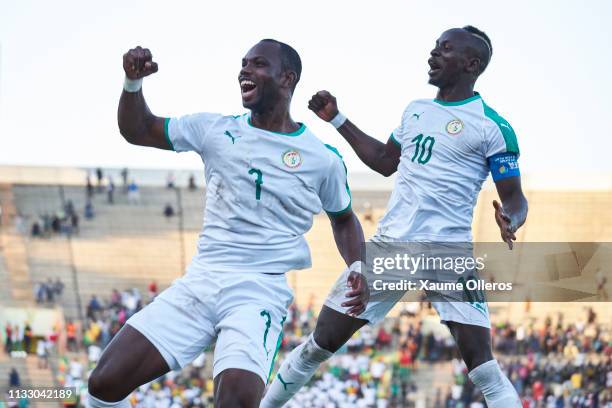 Moussa Konate and Sadio Mane celebrate after scoring the victory goal during a friendly match between Senegal and Mali after both teams qualified for...