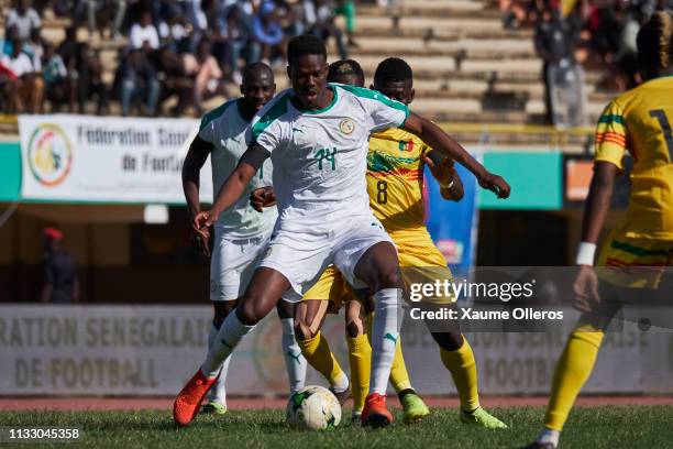 Mamadou Loum Ndaye of Senegal fights for the ball with Idrissa Traore of Mali during a friendly match between Senegal and Mali after both teams...